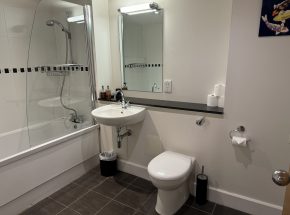 The family bathroom has a bath and shower over bath.