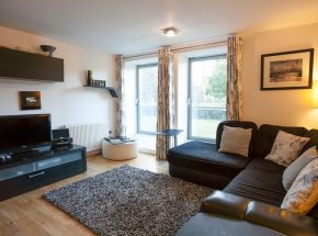 Living area with view of tennis court and the grounds